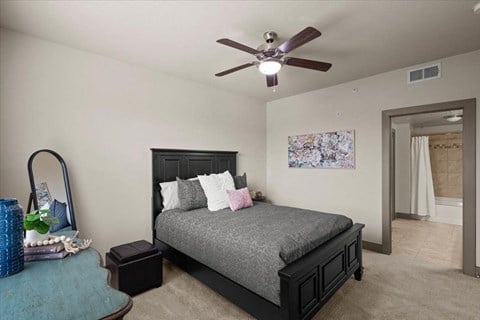 a bedroom with a bed and a ceiling fan